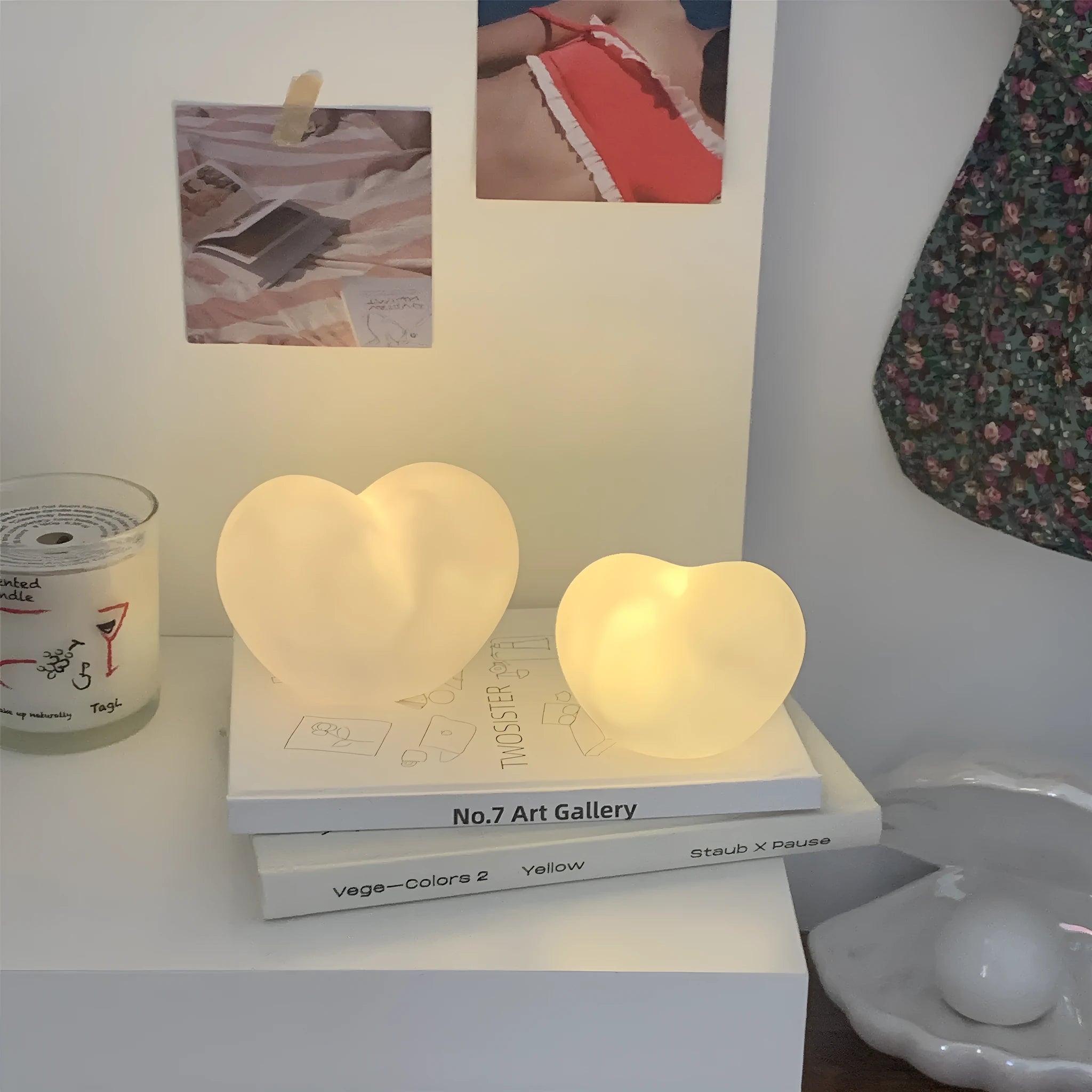 Small white vinyl atmosphere lamp with glowing warm light on a table.