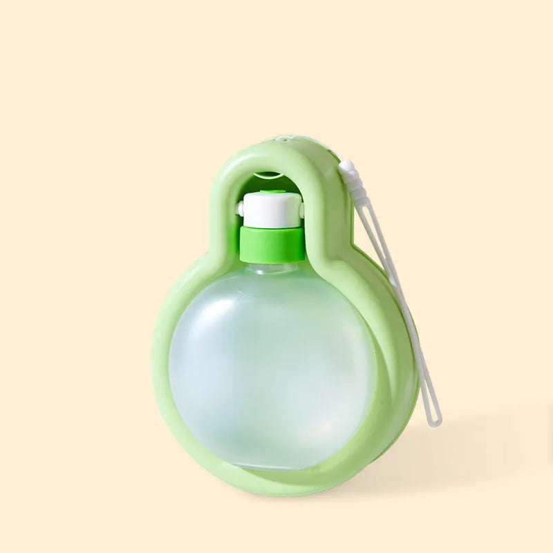 Green dog travel water bottle with integrated drinking bowl for outdoor use