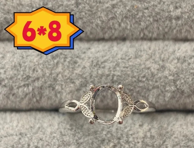 Oval denier ring with five-pointed star ornamentation and 6x8 mm main stone