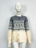 Red women's alpaca wool cardigan with grey diamond knit pattern and long sleeves.