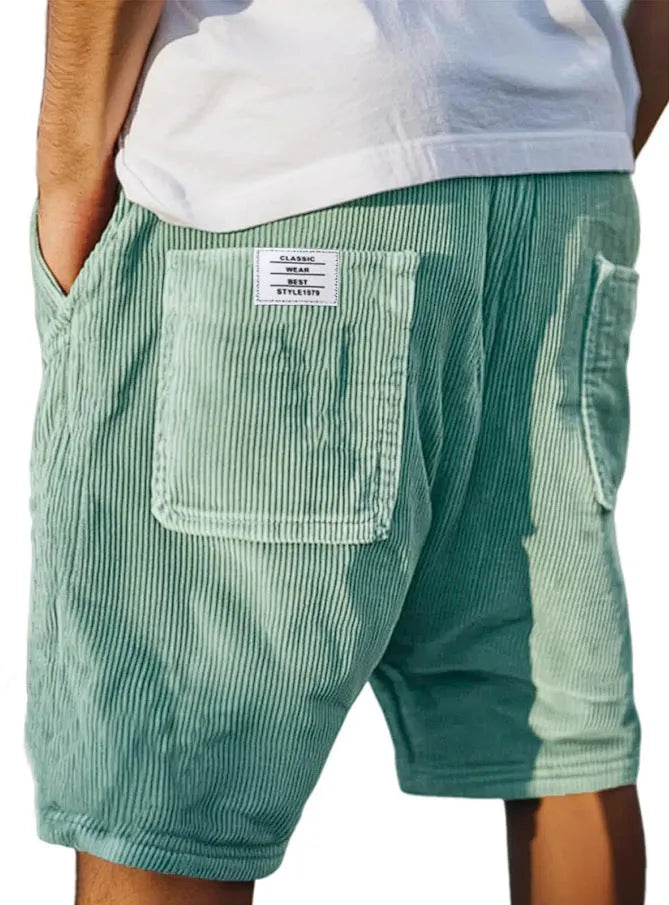 Men's grey corduroy shorts with embroidered detail on multiple pockets, laid flat.