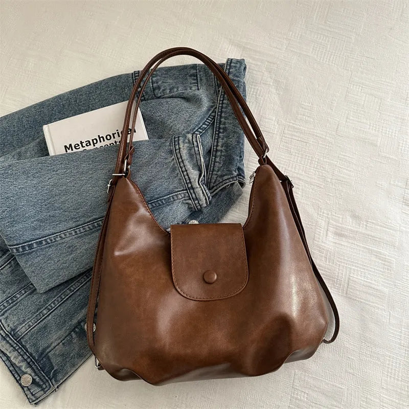 Women's PU leather commuter shoulder bag in horizontal square shape with single strap and optional pendant