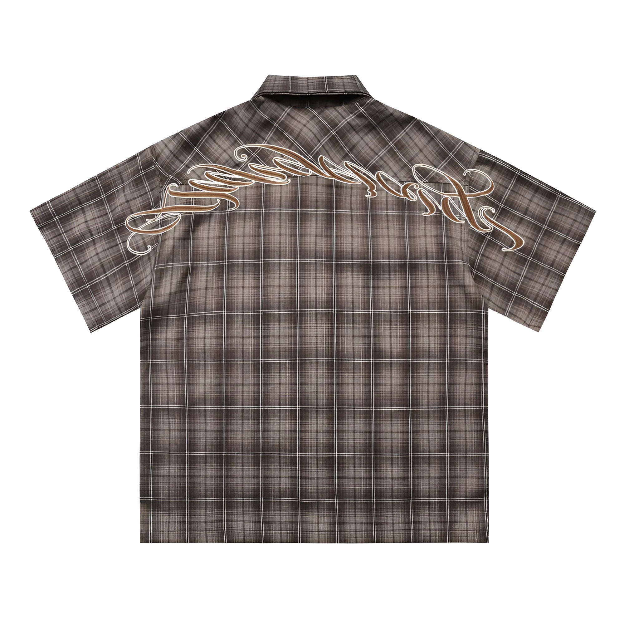 Man wearing a black and brown plaid short sleeve shirt with embroidered letters on the lapel