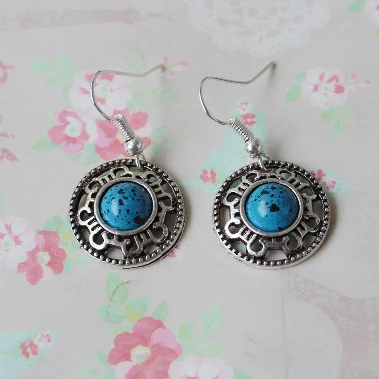 Geometric turquoise flower disk earrings in Miao silver with ethnic patterns