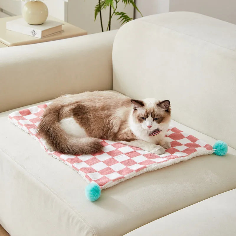 Green plaid plush pet blanket for dogs and cats on a sofa
