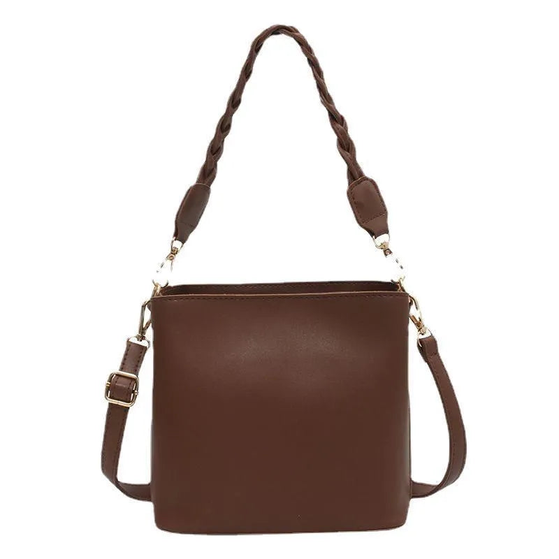 Retro woven PU leather crossbody bucket bag in khaki colour showing underarm design and textured surface