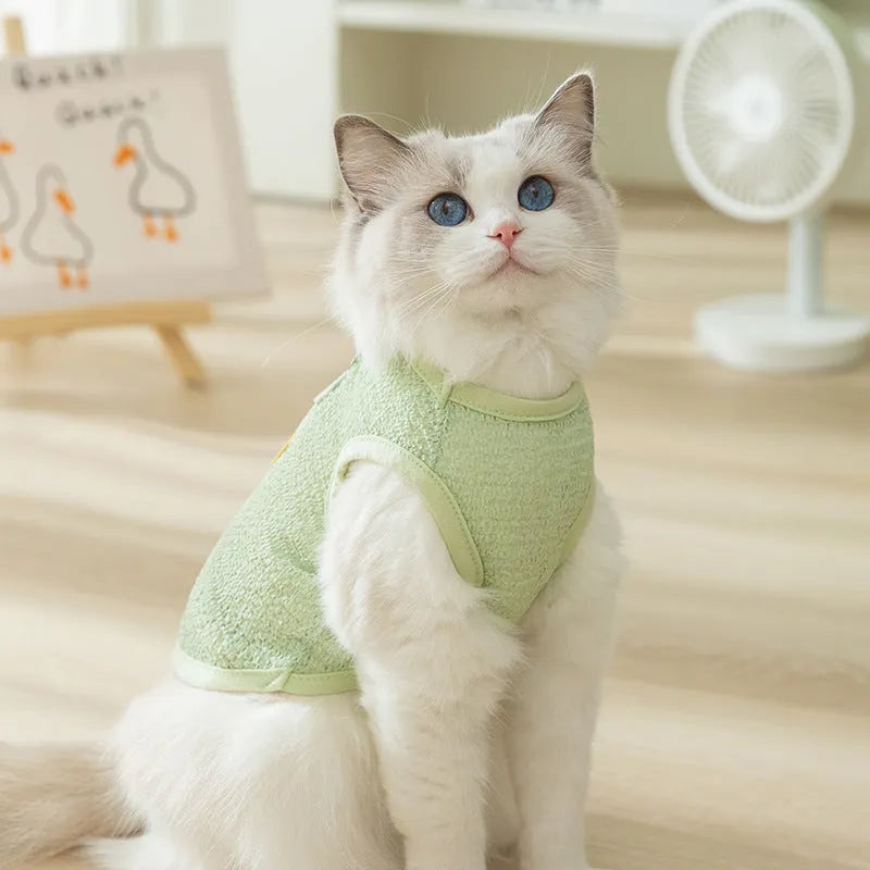Green cat jumper with bear patch design showing breathable knitted fabric
