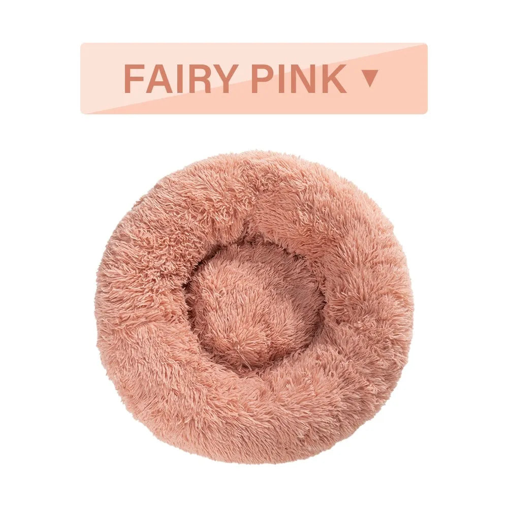 Fluffy donut-shaped pet bed in long plush fabric, shown in a light grey colour.
