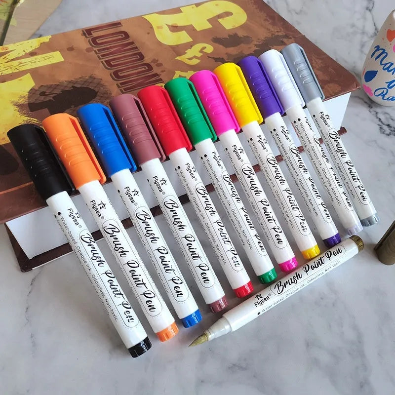 Set of acrylic gouache marker pens for hand-lettering and greeting card art projects in various colours.