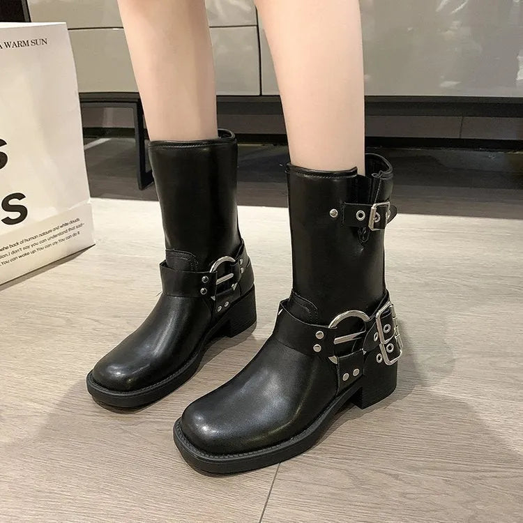 Women's black platform boots with a silver buckle detail at mid-calf height.