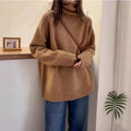 Red women's loose turtleneck sweater with a thick, textured curling pile collar.