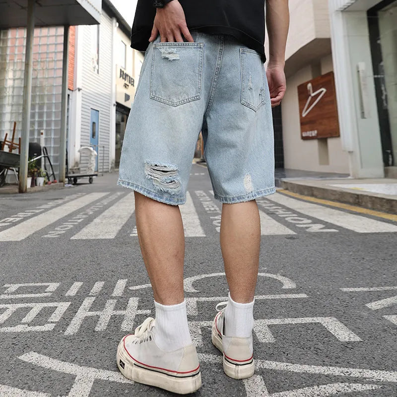 Light blue ripped denim shorts with a loose straight-leg fit on a mannequin.