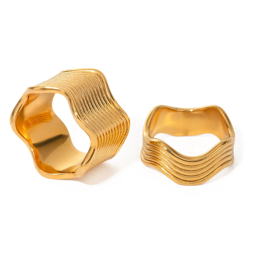 A stainless steel women's ring with a wide, geometric wave design in a Korean style.