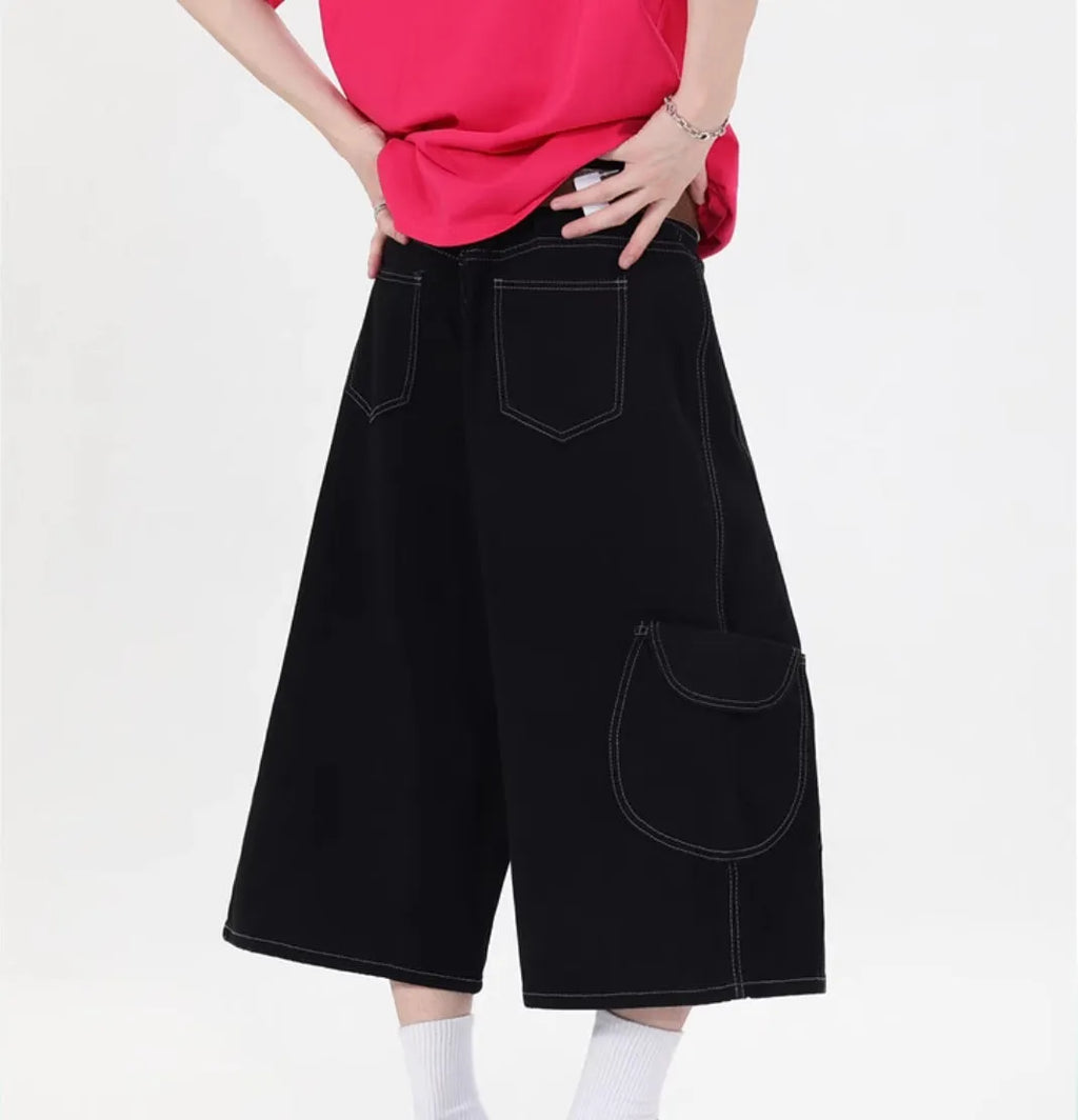 Retro denim multi-pocket workwear shorts in a wide leg cropped style, shown in red and black.