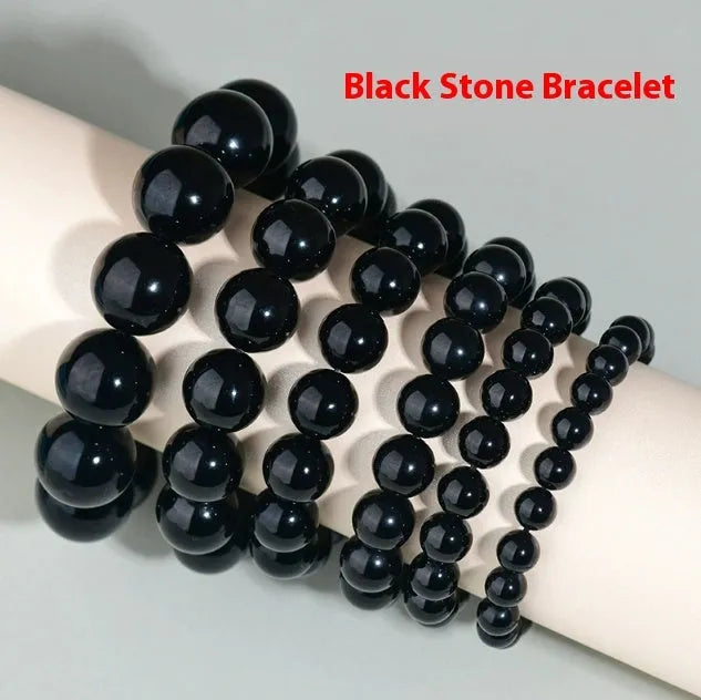Hand-woven obsidian bracelet with round beads and engraved birth year detail for couples