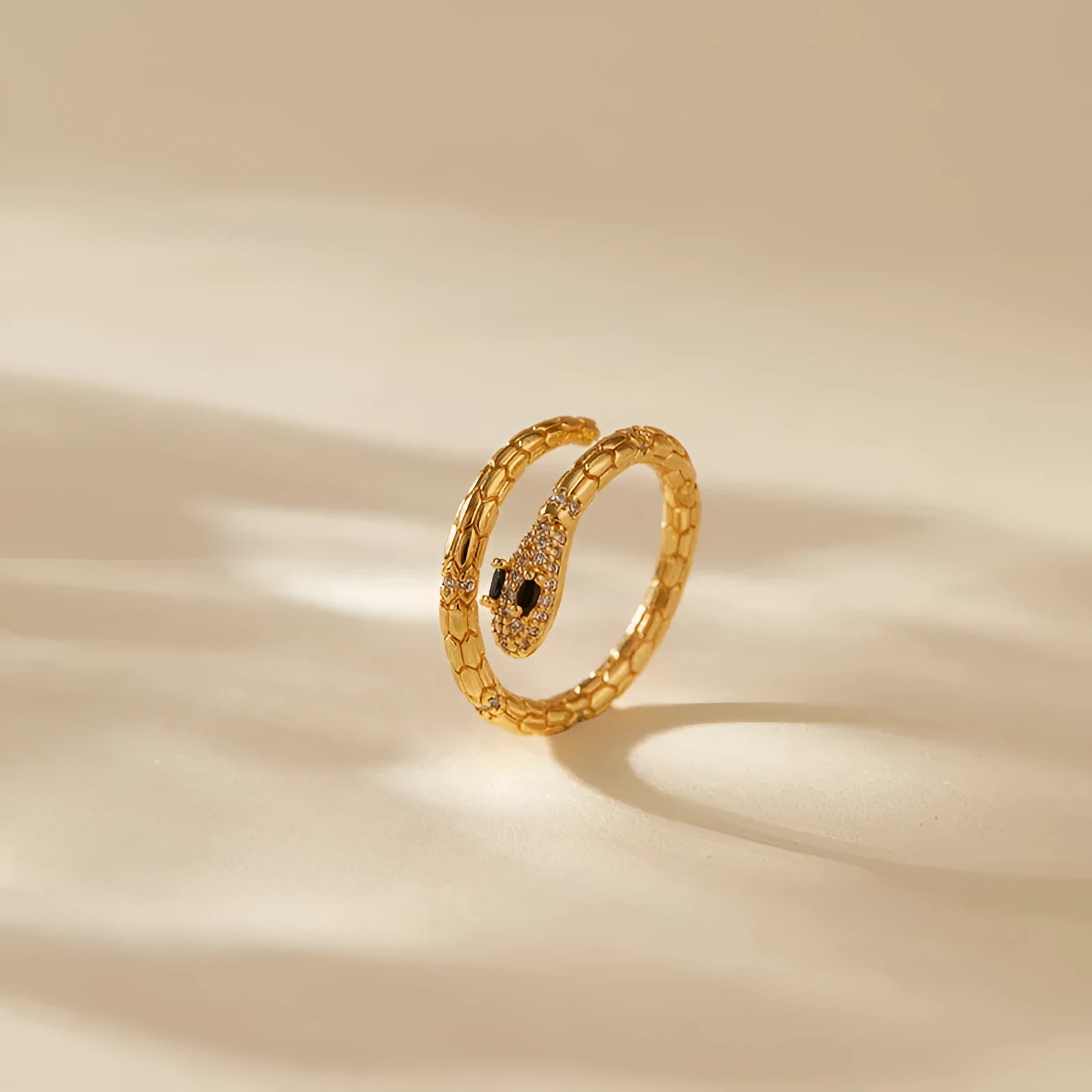Adjustable copper snake ring with 18K gold plating on index finger