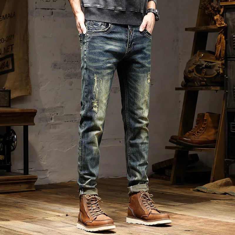Men's skinny fit retro blue jeans with a zip fly on a plain background