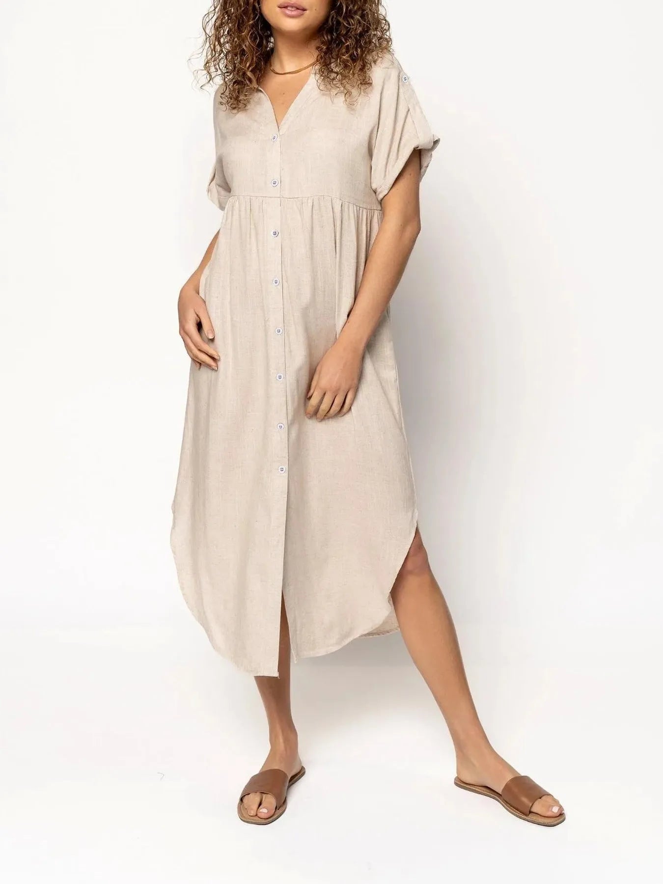 A woman wearing a casual solid-colour mid-length dress with a button-down front.