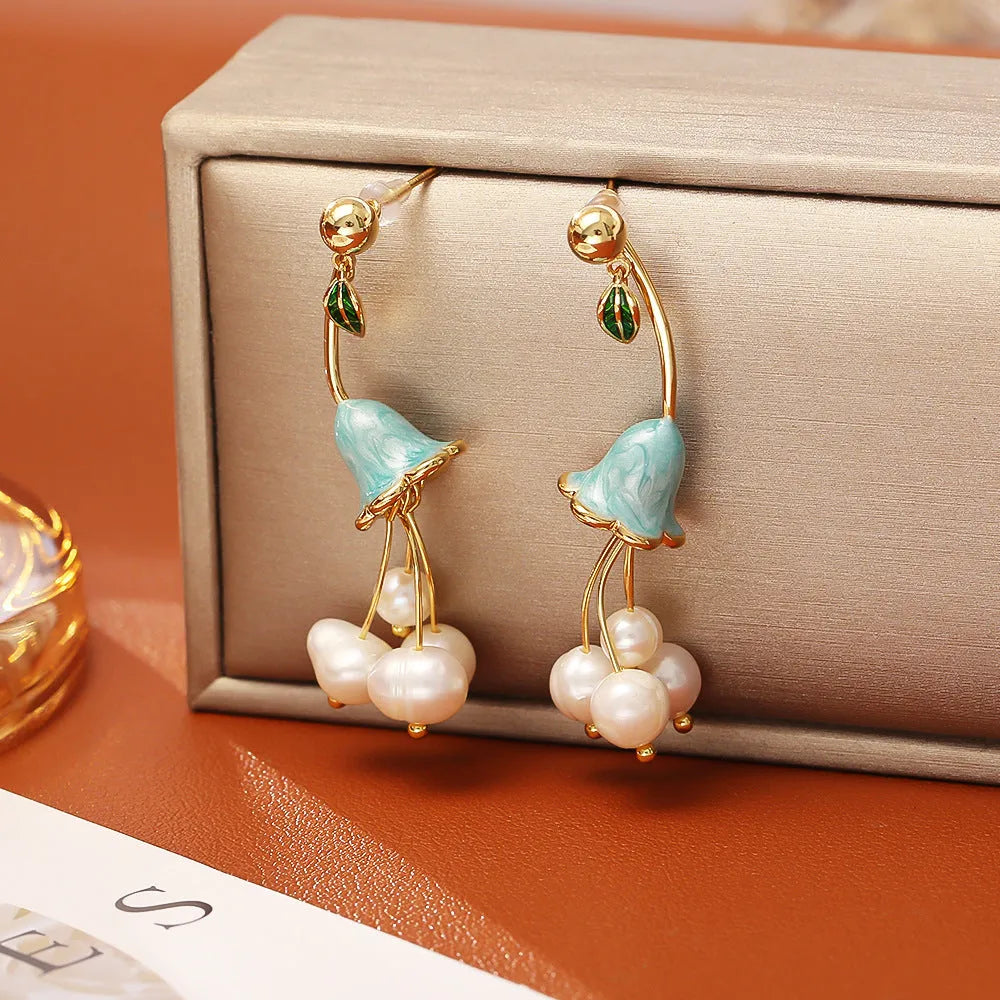 Natural baroque pearl ear studs in lily flower shape with gold plating on copper base
