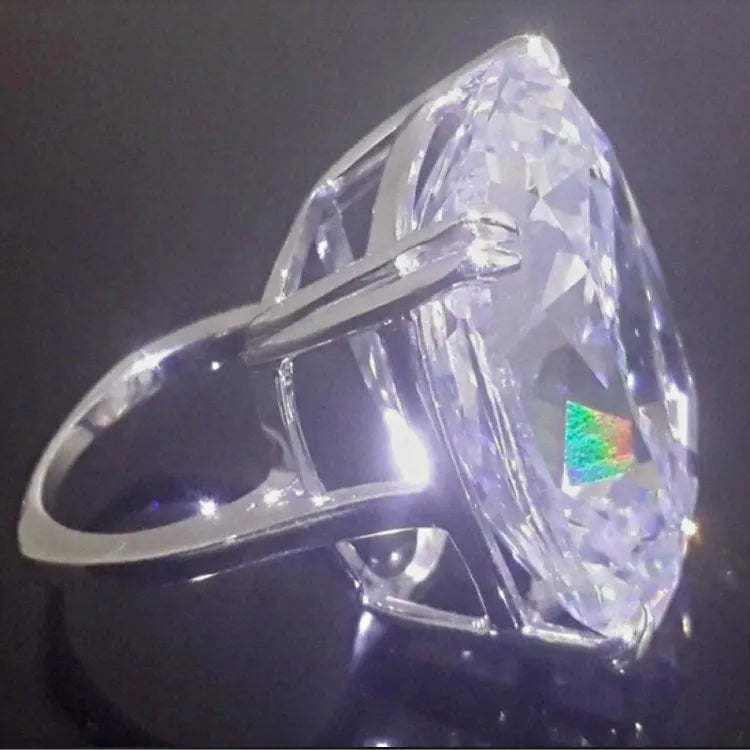 Simple white gold colour alloy ring with a geometric design and an inlaid square diamond.