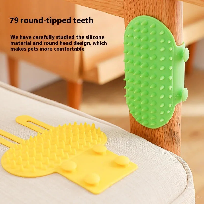 Silicone cat grooming comb with adjustable strap mounted on a table leg, shown in assorted colours.