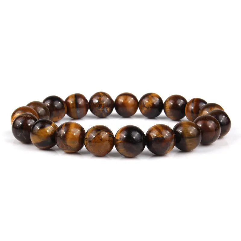 Tiger eye crystal stone bracelet showing round beads available in multiple colours and sizes on a wrist.