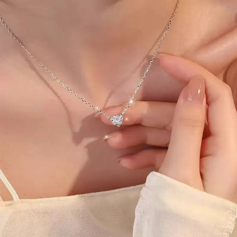 Silver-coloured copper heart pendant necklace on a chain, simple refined graceful design