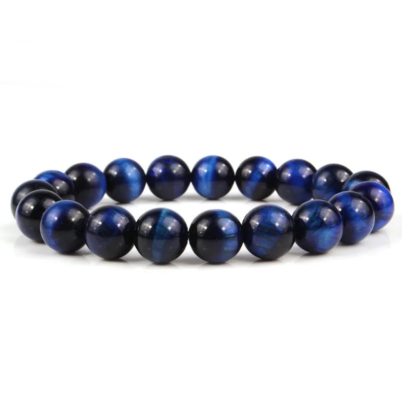 Tiger eye crystal stone bracelet showing round beads available in multiple colours and sizes on a wrist.