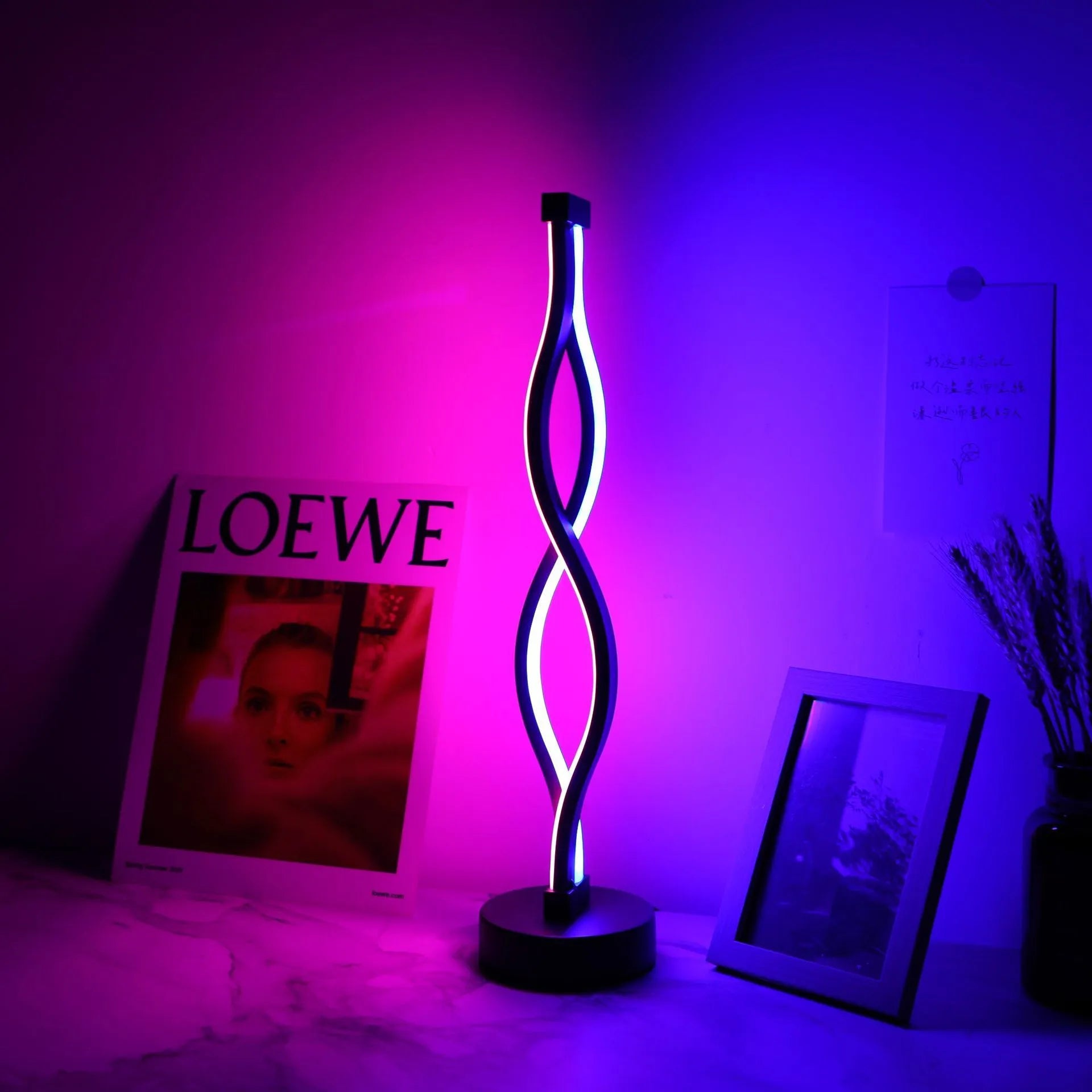 Black aluminium desk lamp with touch dimming buttons in blue and pink, showing three colour temperature modes