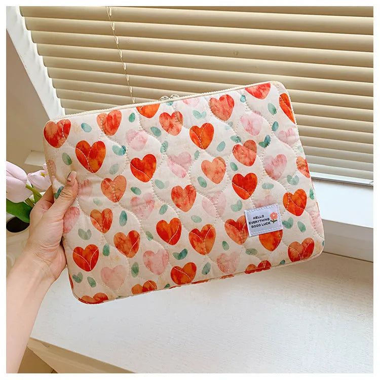 Flower print cloth laptop bag in green floral pattern showing three size options for laptop protection
