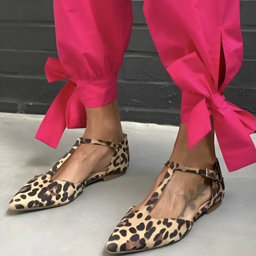 Women's leopard print pointed toe pumps with a chunky low heel and cross shoulder straps.