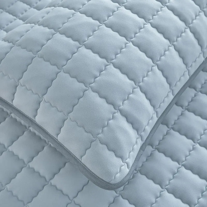 Blue waterproof washed cotton fitted sheet with elasticated edge on a mattress