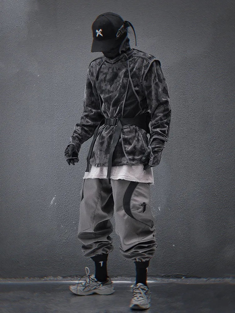 Man wearing a black and grey tie dye printed finger turtleneck sweater with drop shoulder sleeves.