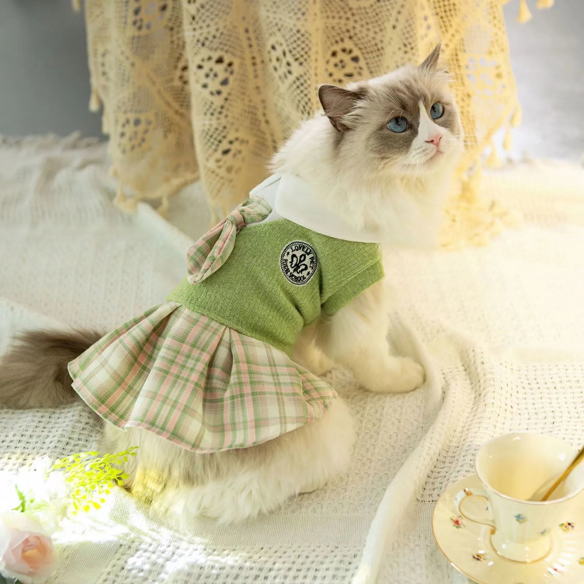 A pink tartan skirt for a small dog, showing the elastic waistband and princess-style flare.