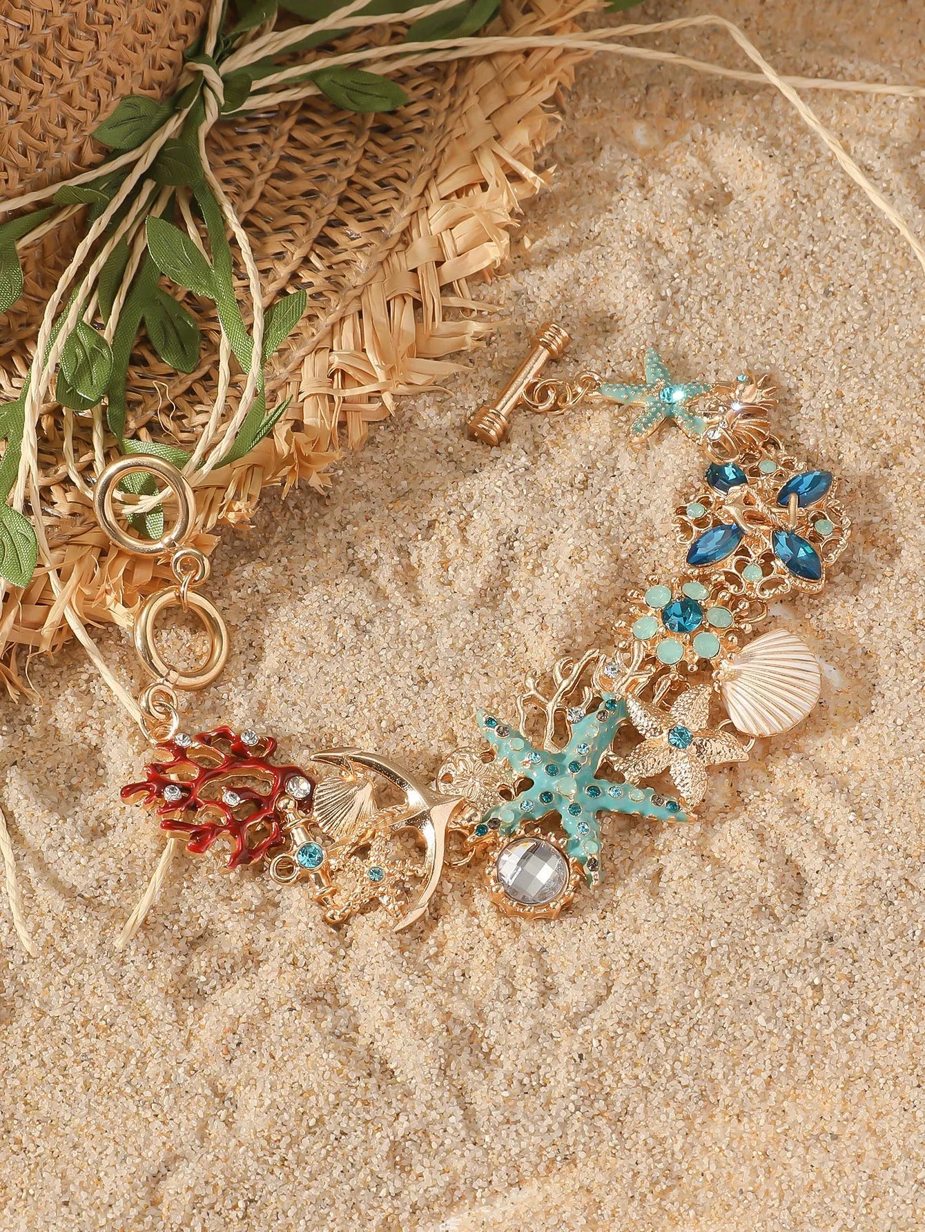 Alloy rhinestone starfish bracelet with boat anchor charm in blue, red, or turquoise.