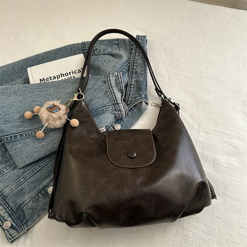 Women's PU leather commuter shoulder bag in horizontal square shape with single strap and optional pendant