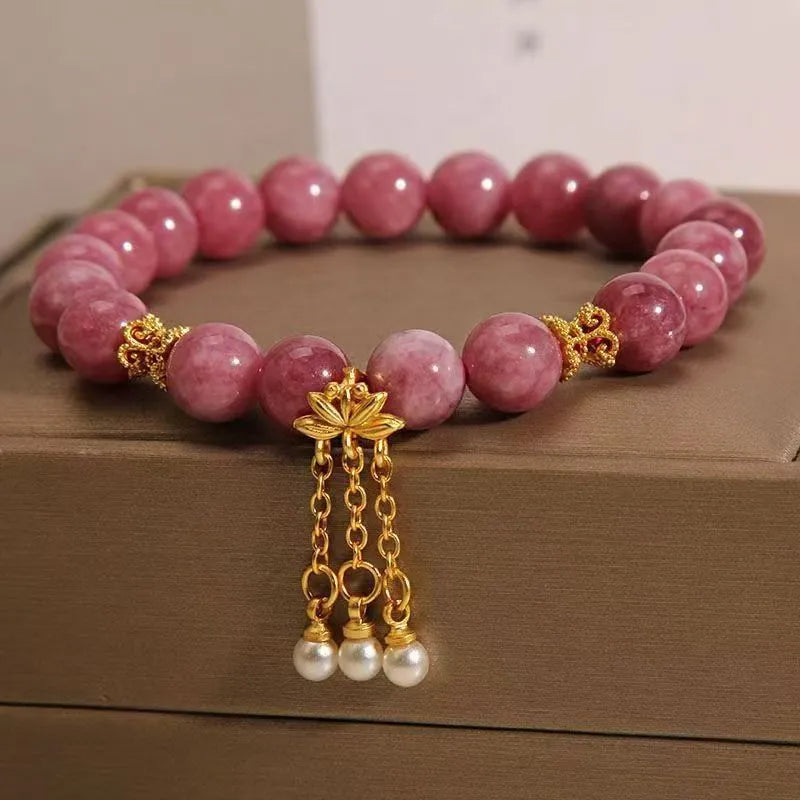 Natural stone bracelet with lotus tassel pendant and pearl details in pink lotus colour