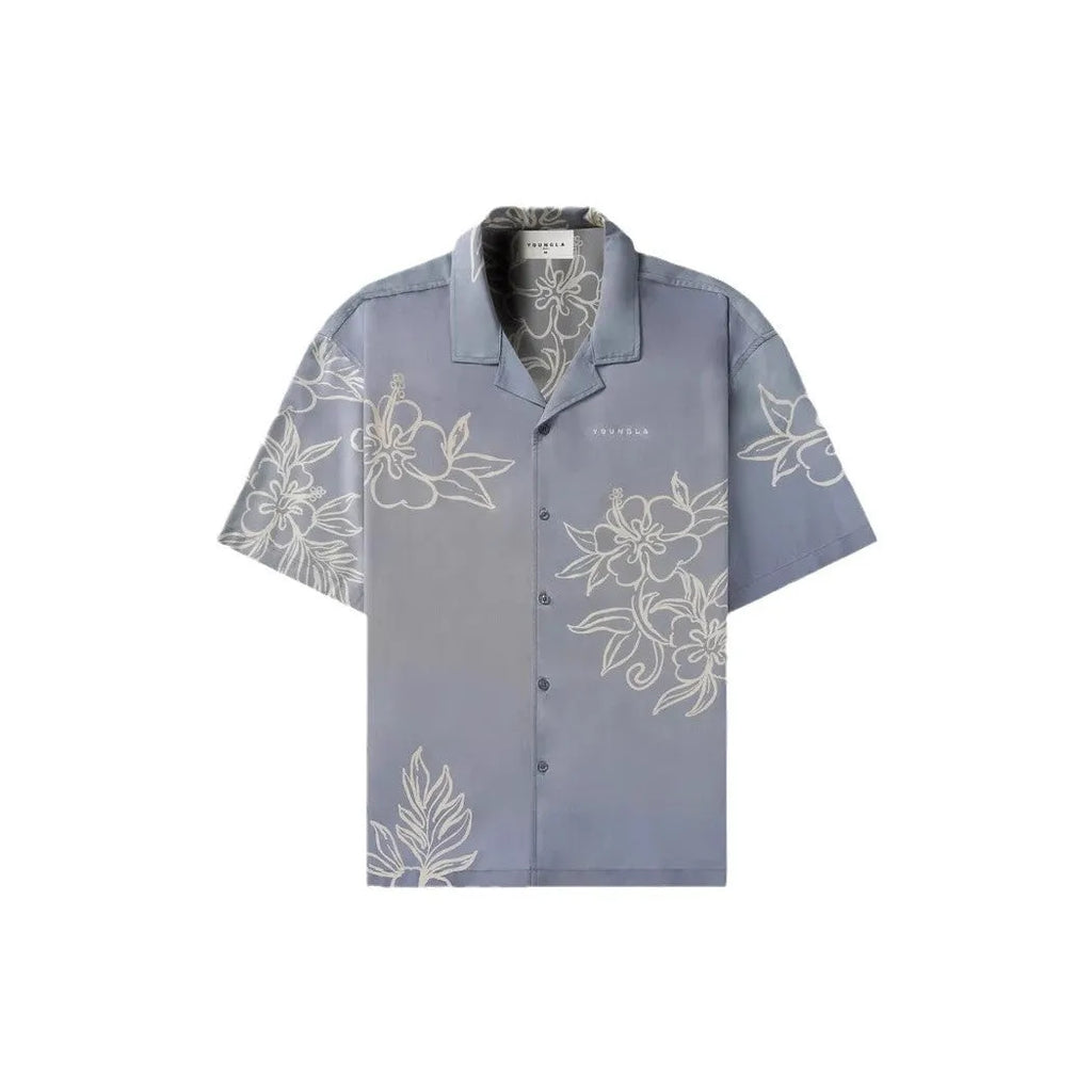 Man wearing a loose grey short sleeve cardigan top with a white floral print pattern.