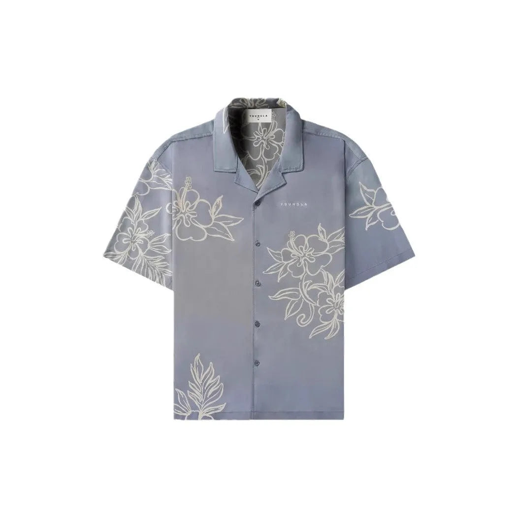Man wearing a loose grey short sleeve cardigan top with a white floral print pattern.