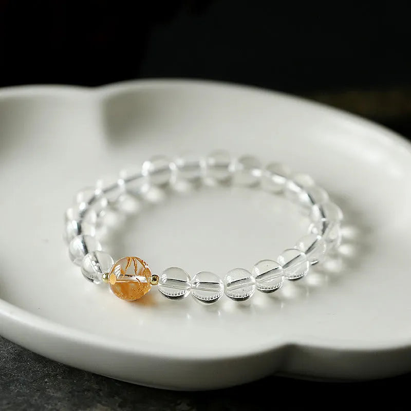 Geometric unisex bracelet with black obsidian agate beads, white crystal beads, and a golden dragon crystal focal bead.