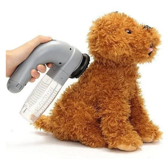 Grey portable electric pet hair removal brush with soft rubber head for grooming dogs and cleaning sofas.