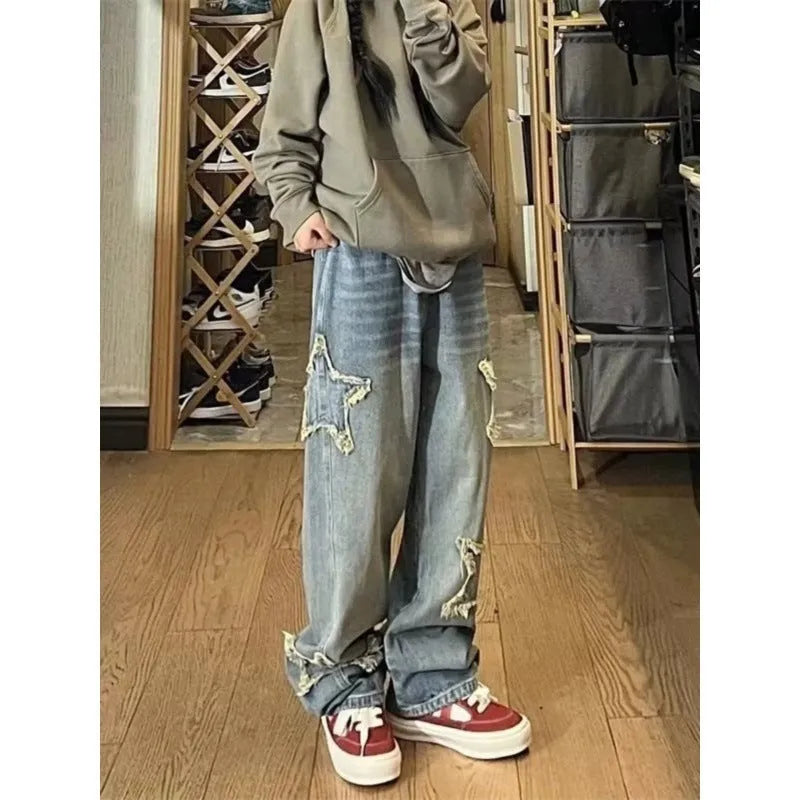 Blue high-waisted wide-leg denim jeans on a hanger showing straight-leg cut.