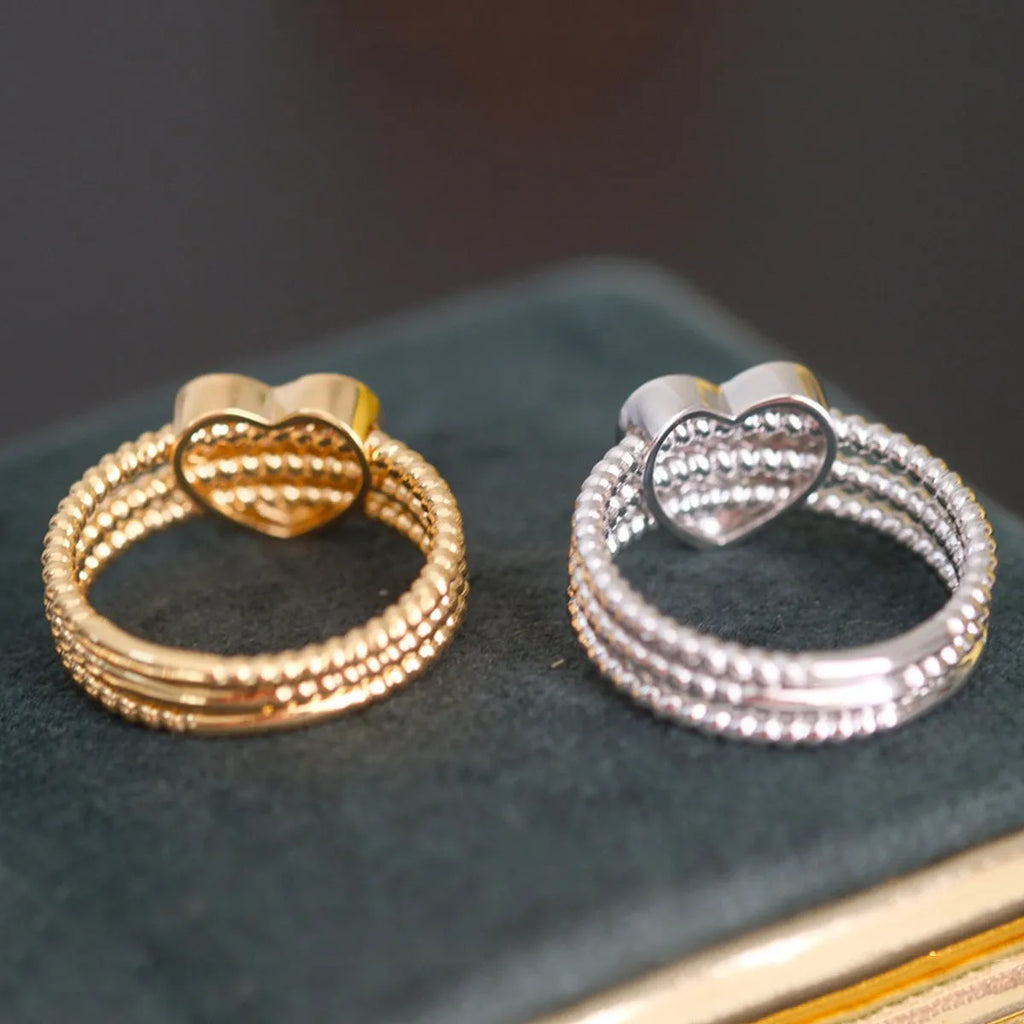 S925 sterling silver ring with heart twist design, available in white gold or yellow gold finish, US sizes 6 to 10