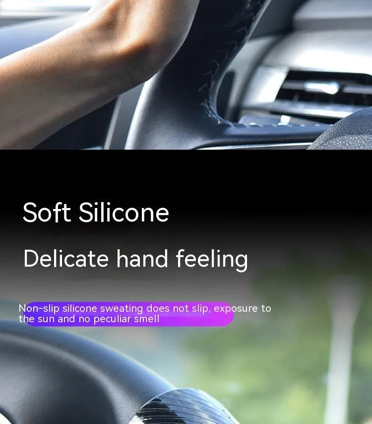 Close-up of black silicone steering wheel assist ball with metal bearing mechanism attached to a car steering wheel rim