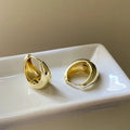 Pair of simple retro geometric alloy earrings in gold electroplated finish on a light background