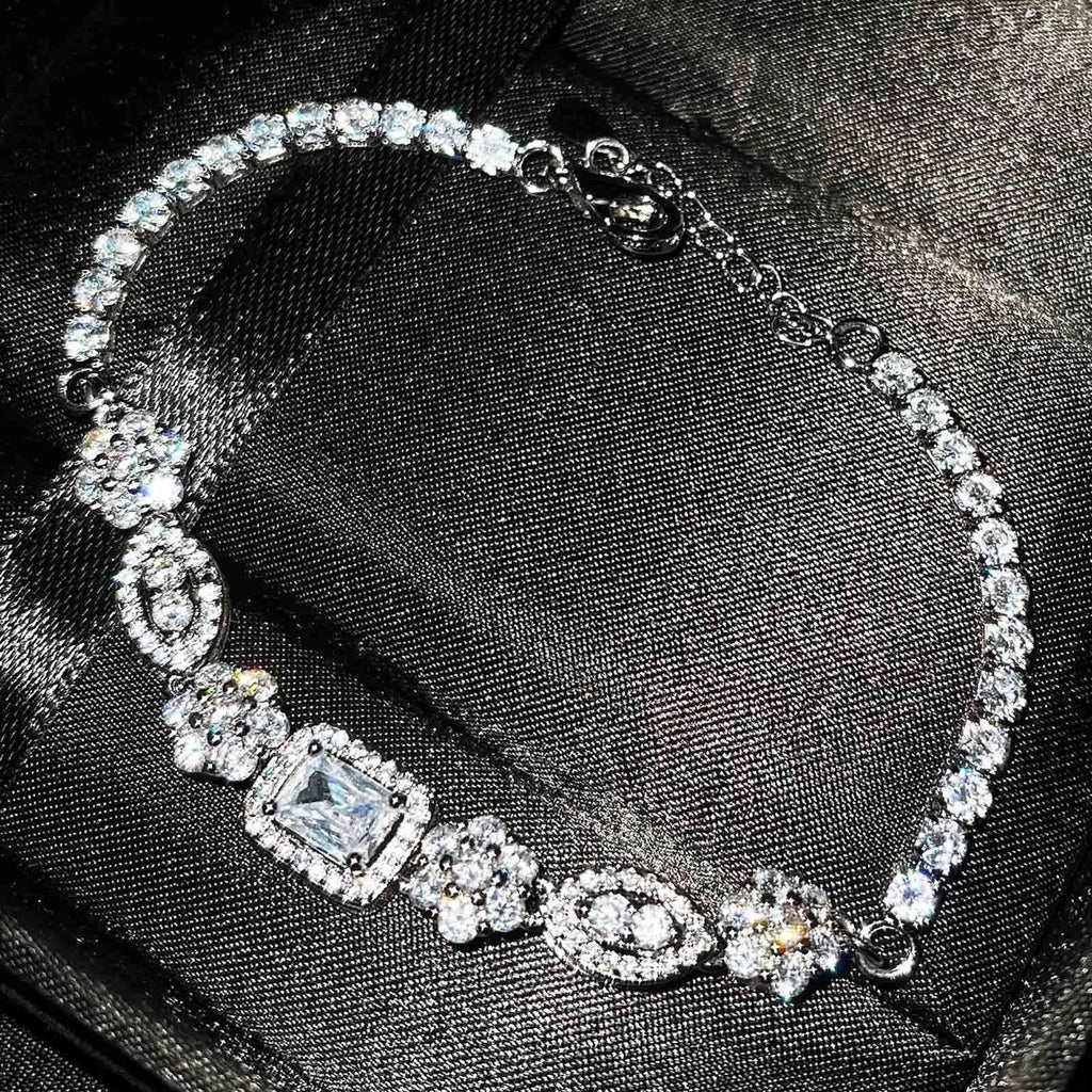 Women's geometric bracelet with silver and white gold plating and sparkling inlaid zircon stones.