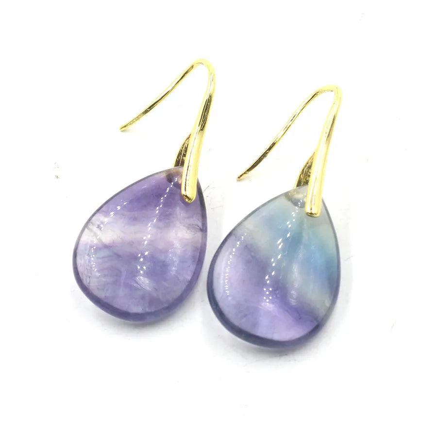 A pair of geometric water drop earrings made from crystal in one of nine colours, with an electroplated metal setting.