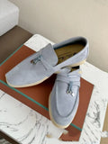 Unisex high-top slip-on loafers with a round toe cap and rubber sole on a neutral background.