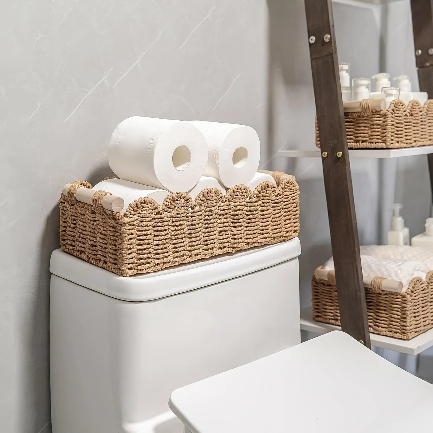 Woven paper storage basket in khaki colour on a desktop, holding remote controls and stationery.