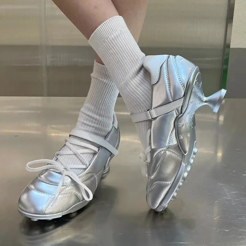 Women's silver lace-up sports shoes with a bow detail and round toe on a mid heel.